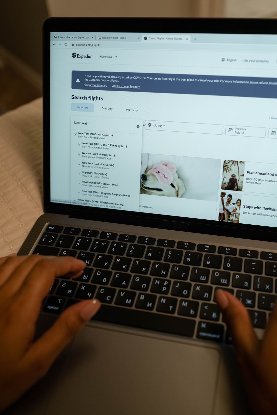 A person using a laptop to search travel information.